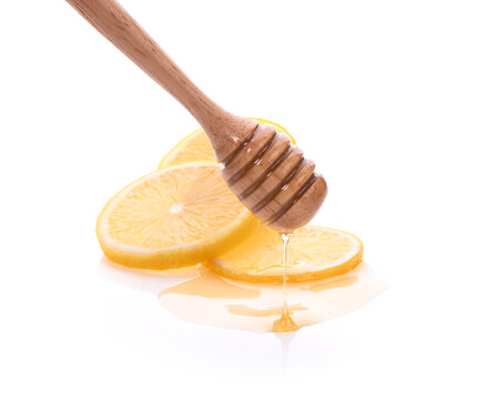 Honey Dripping On Fresh Lemon Isolated White Background