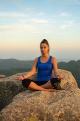 Fototapeta na wymiar meditating girl on the mountain