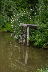 wooden staircase near the lake to a cottage in Romania