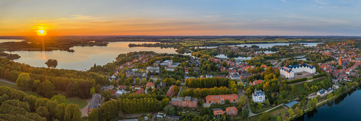 Panorama aerial view of castle Plon (Plöner Schloss) on the shore of lake Plon (Plöner See) and its surrounding landscape Schleswig-Holstein, Germany