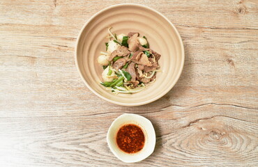 dry braised pork and ball with bean sprout  on bowl dipping spicy sauce