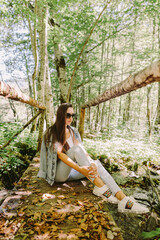 woman relax in autumn forest. Woman travel countryside on vacations. Enjoying golden leaf forest