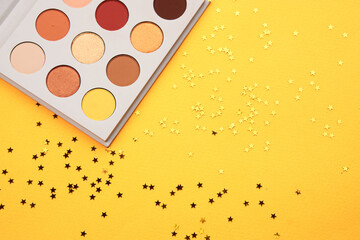 eyeshadow on a yellow background and glitter decorations