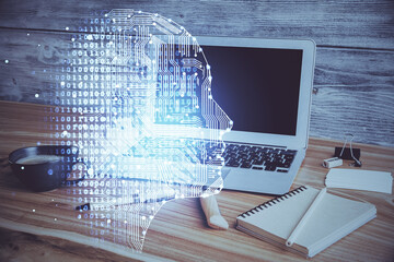 Double exposure of work space with computer and human brain drawing hologram. Brainstorm concept.