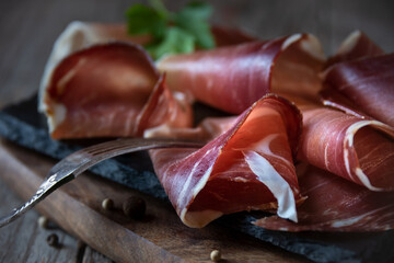 Italian prosciutto or jamon with rosemary, raw ham