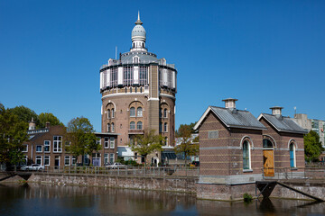Fototapeta na wymiar Water tower and basin with portal structure in Rotterdam, The Netherlands, on a sunny day against a blue sky