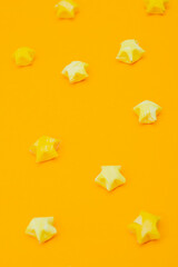 Solid yellow background with paper stars in a children's style. Template for scrapbooking.