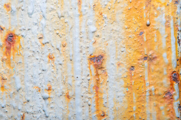 Light background with an old metal surface with streaks of rust and peeling paint. Fine details at high magnification. Photo with soft focus and blurred backdrop.