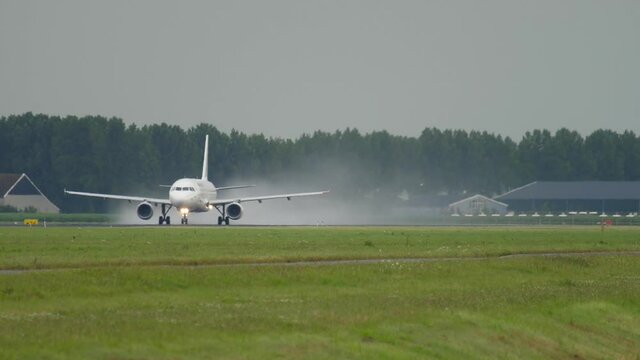 Jet airliner speeding up along the runway to take off