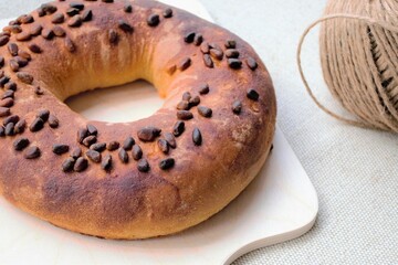 Homemade bagel with poppy seeds on a wooden board
