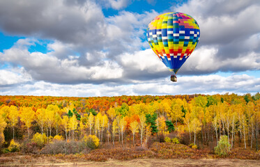 Amazing view of colorful autumn trees with hot air balloon. Concept for fall background. Artistic picture. Beauty world.