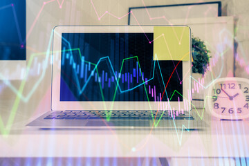 Forex market chart hologram and personal computer background. Multi exposure. Concept of investment.