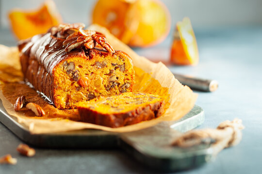 Delicious pumpkin pecan and raisin cake on cutting board. Loaf of pumpkin bread.