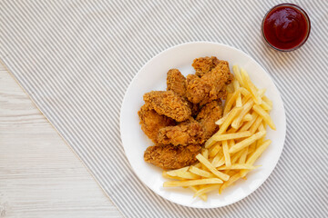 Homemade Crispy Chicken Wings and French Fries with ketchup, top view. Overhead, from above, flat lay. Copy space.