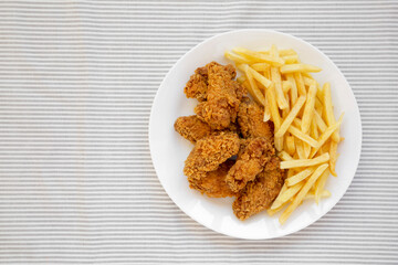 Homemade Crispy Chicken Wings and French Fries, top view. Overhead, from above, flat lay. Space for text.
