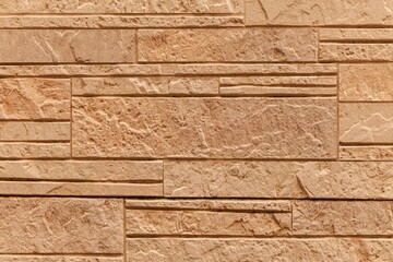 Block pattern of brown stone cladding wall tile texture and seamless background