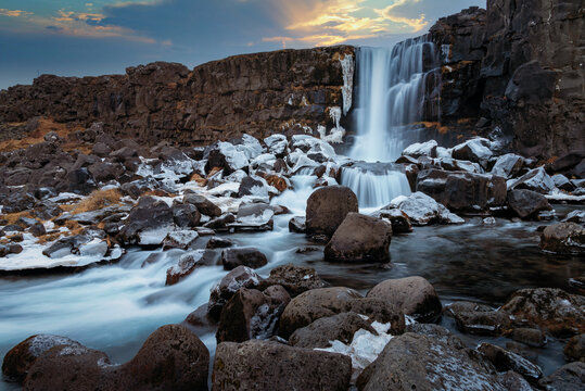 Oxararfoss waterfall in Pingvellir National Park in iceland. Edit picture for beautiful sky, clouds and sunlight.