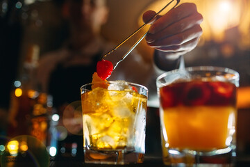 The bartender prepares cocktails at the bar.