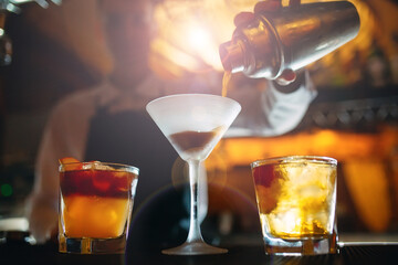 The bartender prepares cocktails at the bar.