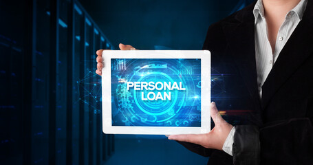 Young business person working on tablet and shows the inscription: PERSONAL LOAN, business concept