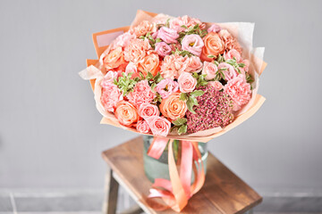 Bouquet Peach and orange color. Beautiful bunch mixed flowers in wooden table. the work of the florist at a flower shop. Fresh cut flower.
