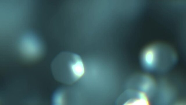 Beautiful rounded hexagon bokeh. Dynamic texture. Glowing light leaks footage. Camera lens blur realistic effect. Slow motion. Optical flare and glow. For video compositing, transitions, into. 4K clip