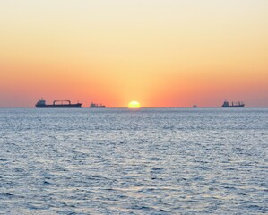 Fototapeta premium The setting sun seems to be sinking into the sea...