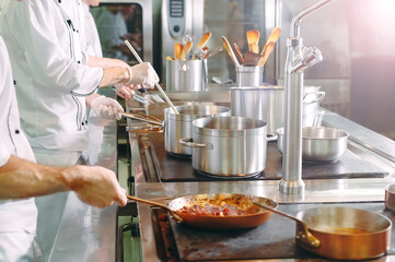 Chef cooking vegetables in wok pan. Shallow dof.