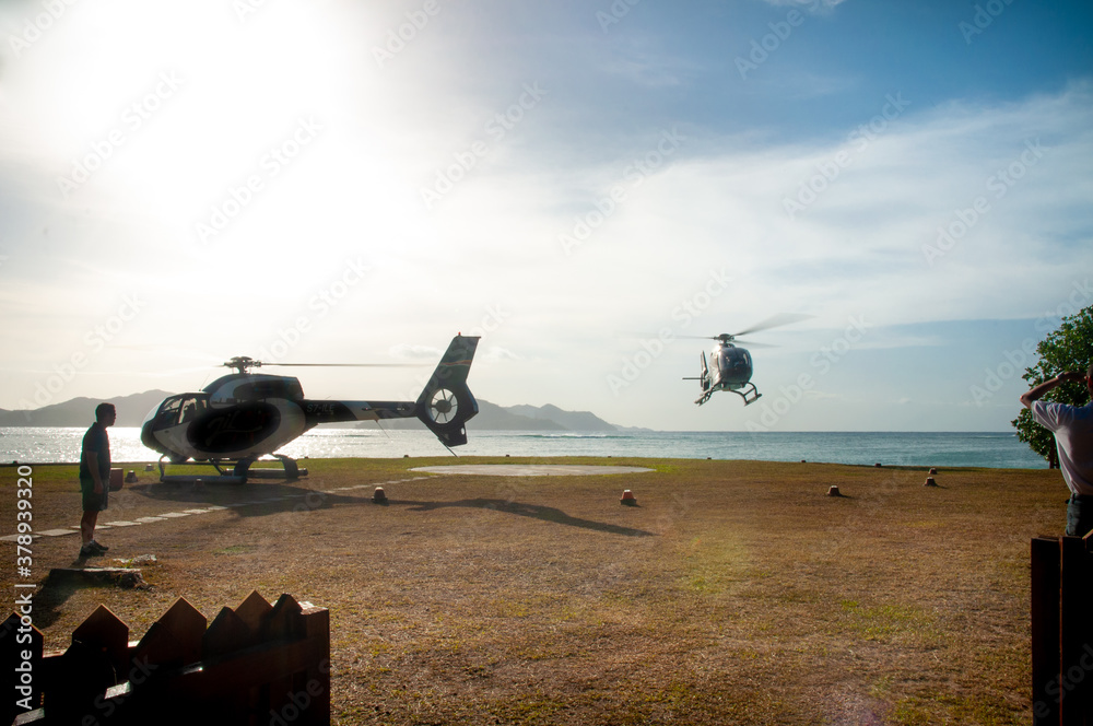 Wall mural Helicopter landing on a tropical island 