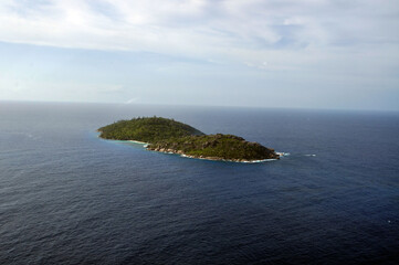 Aerial view of a tropical island with coastline and blue ocean. Félicité Island, La Digue, Seychelles