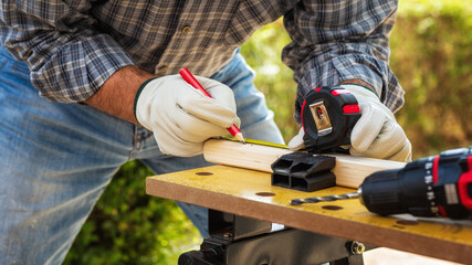 Carpenter at work on wooden boards. Carpentry.