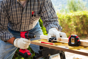 Carpenter at work on wooden boards. Carpentry.