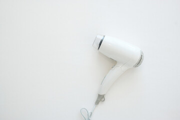 White Hair dryerl on bed at luxury hotel or modern home with copy space for text