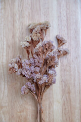 Bunch of dry flowers on wooden floor