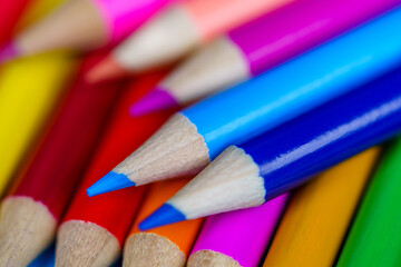 Fototapeta premium Heap of colorful pencils with blurred background. Close up photo