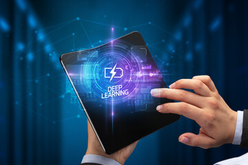 Businessman holding a foldable smartphone with WEB DESIGN inscription, new technology concept DEEP...