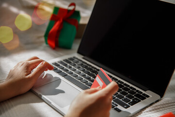  girl enters credit card details into laptop while shopping. selective focus 