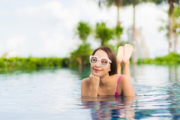 Portrait beautiful young asian woman relax enjoy around outdoor swimming pool