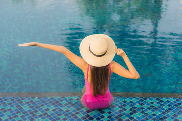Portrait beautiful young asian woman relax enjoy around outdoor swimming pool
