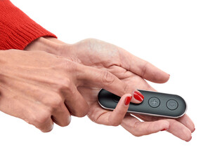 Miniature remote control in beautiful female hands pointing in the direction of the intended device, isolated on a white background. Concept: easy operation of equipment.