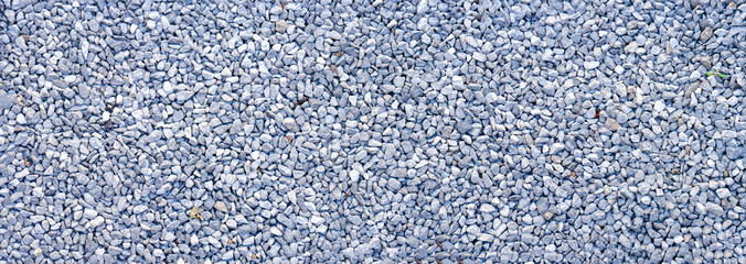 small road stone panorama background. dark gravel pebbles background