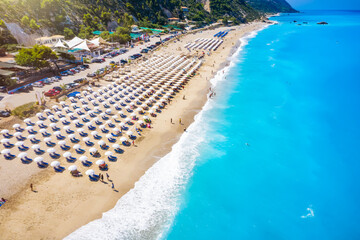 Fototapeta premium The popular Kathisma Beach on the Greek island of Lefkada with blue sea and rows of umbrellas, Greece