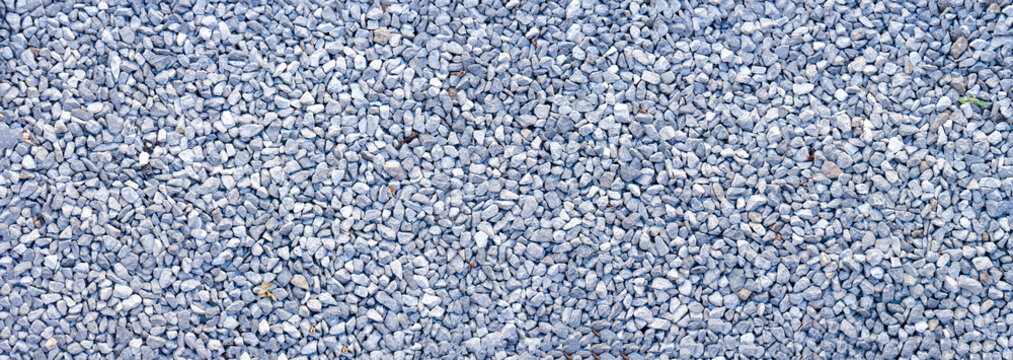 small road stone panorama background. dark gravel pebbles background