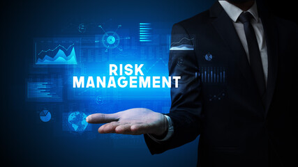 Hand of Businessman holding RISK MANAGEMENT inscription, business success concept