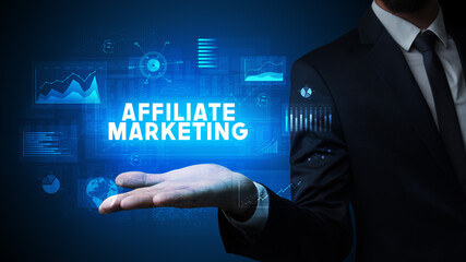 Hand of Businessman holding AFFILIATE MARKETING inscription, business success concept