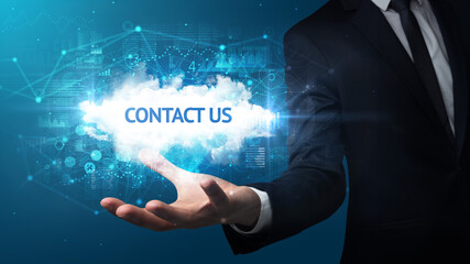 Hand of Businessman holding CONTACT US inscription, successful business concept