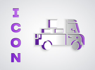 Paper cut Delivery truck with cardboard boxes behind icon isolated on grey background. Paper art style. Vector.