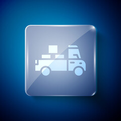 White Delivery truck with cardboard boxes behind icon isolated on blue background. Square glass panels. Vector.