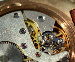 Macro closeup of retro rusty mechanism in the old clock. Gears and wheels inside.
