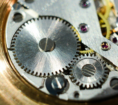 Macro closeup of retro rusty mechanism in the old clock. Gears and wheels inside.